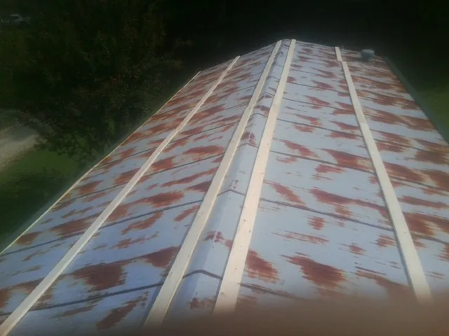 Rusted metal roof panels with new wood purlins before replacement — Storm Damage Roof Repair in Brownsburg by Roofing Brothers